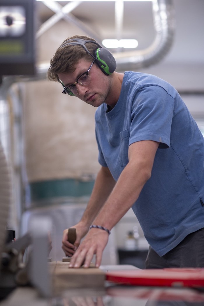 Bowdoin's Thomas Nettesheim '24 works in the shop at Kidwell.