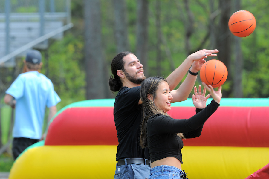 Two students play a game with a ball