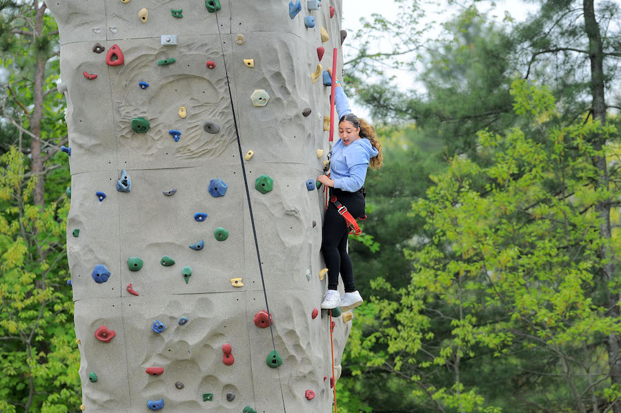 Student climbing a wall