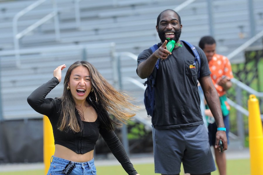 Two students laughing together, playing a game