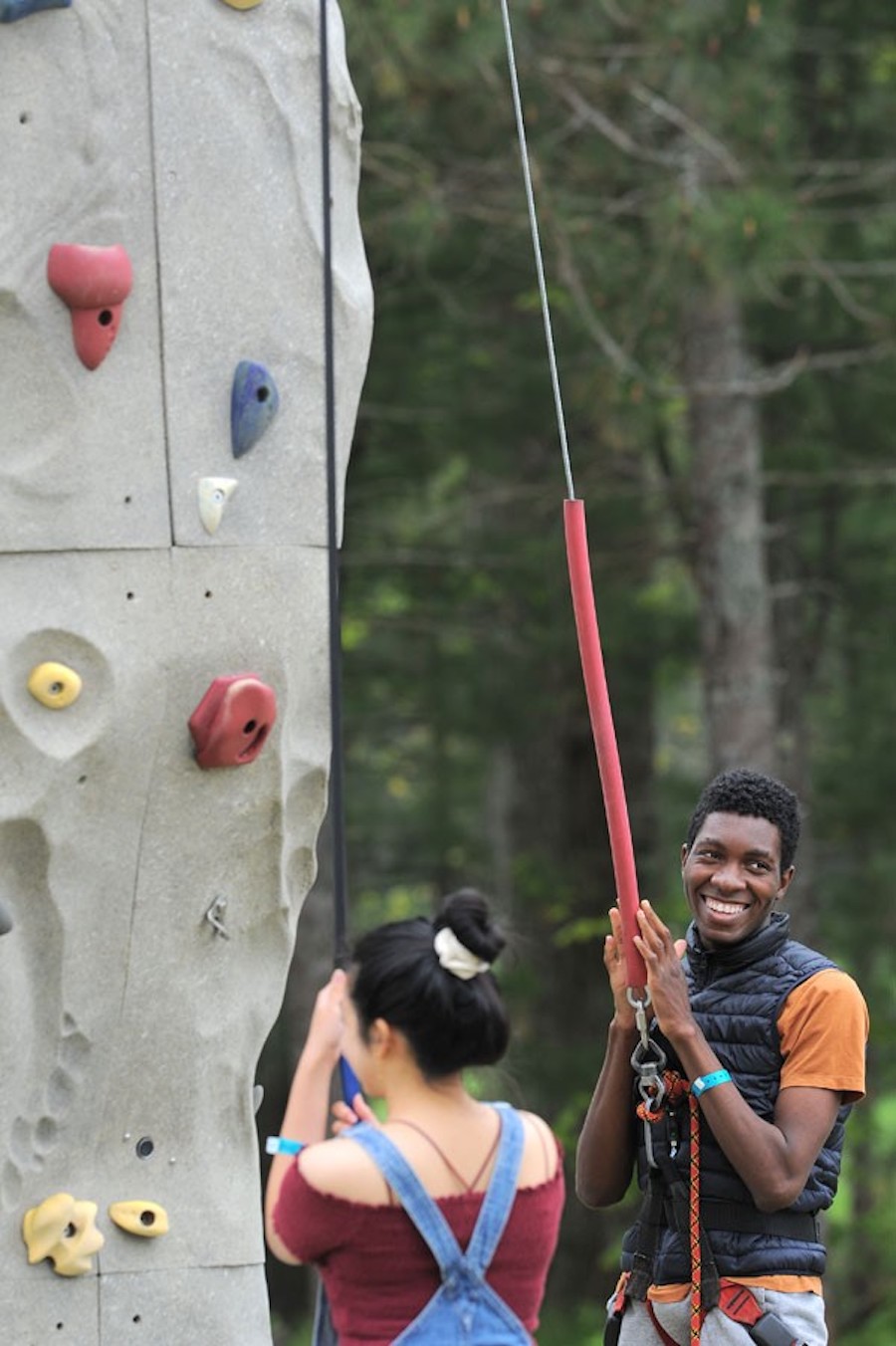 Student standing at bottom of climbing wall