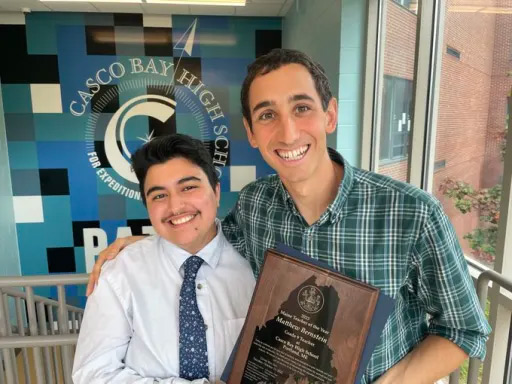 Matthew Bernstein '13 with his award for Maine's 2023 Teacher of the Year