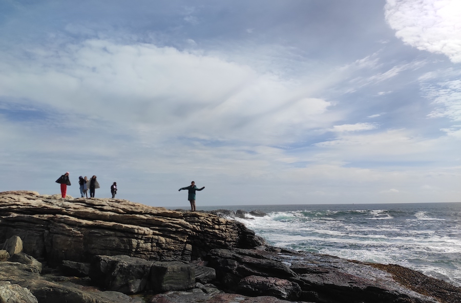 Students on the self-care retreat visit the rocky coast