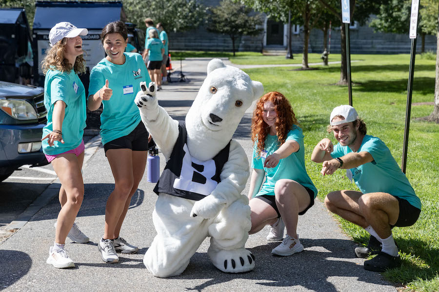 students mingle with the mascot