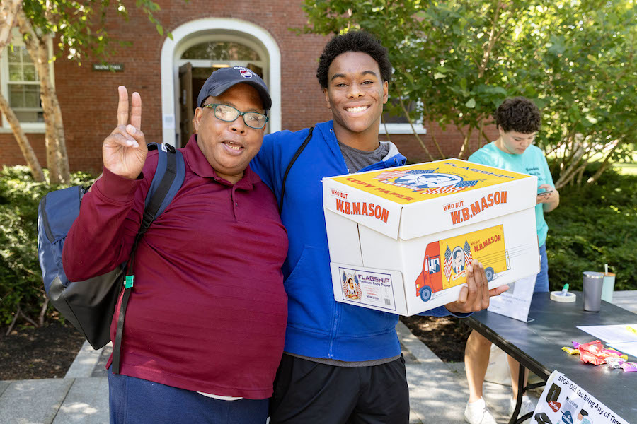 A father with a son gives the peace sign