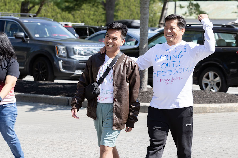 A dad with a funny t-shirt walks with his son