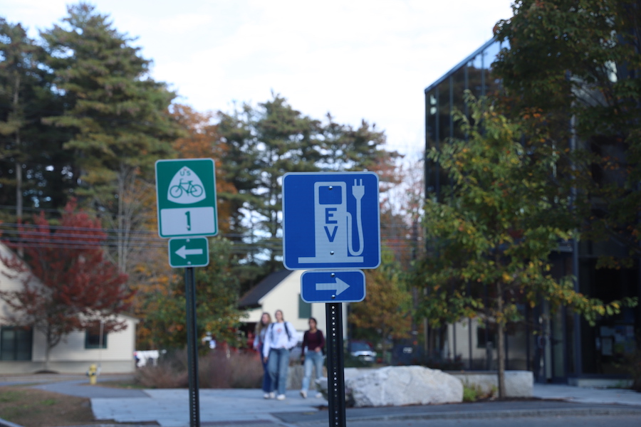 Signs indicate a bicycle route and the EV charging stations near the Roux Center for the Environment.