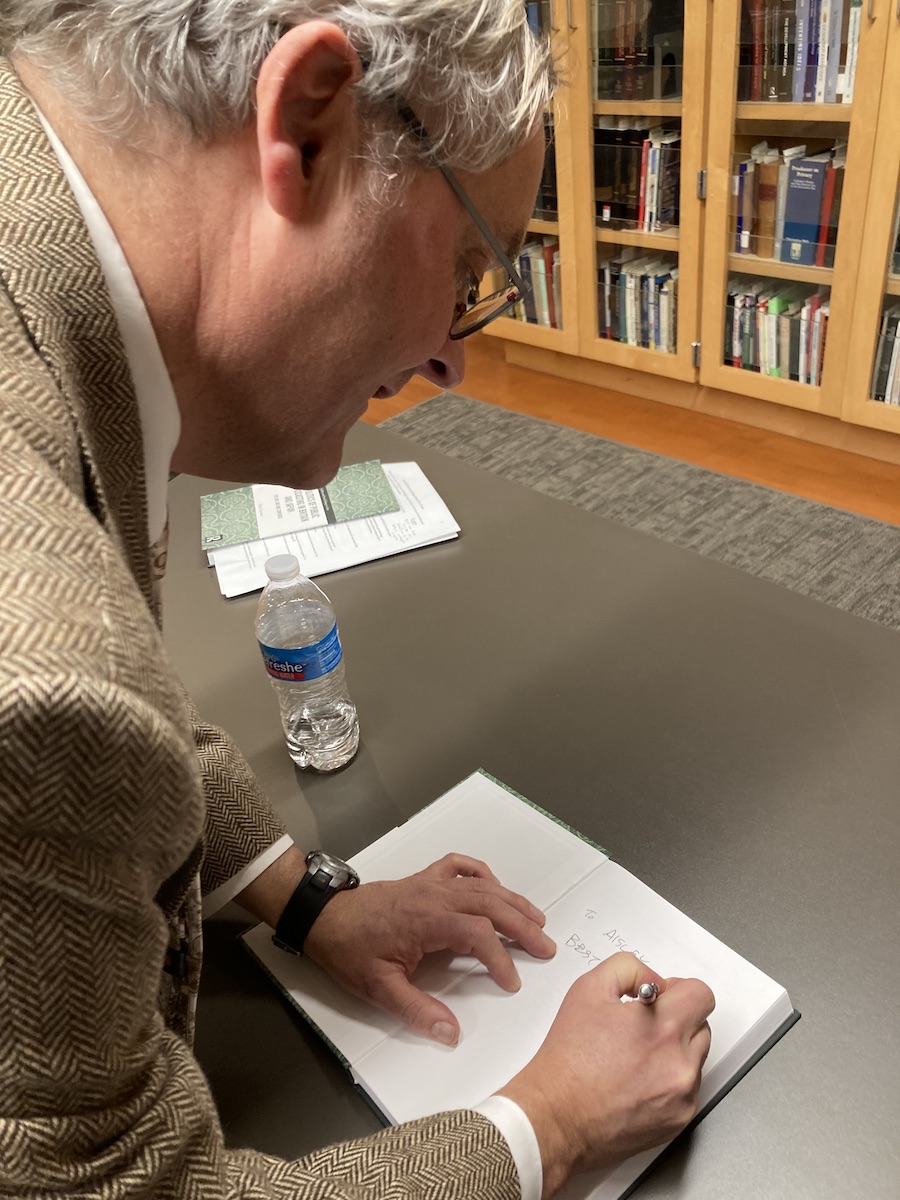 Henry Laurence signs a book