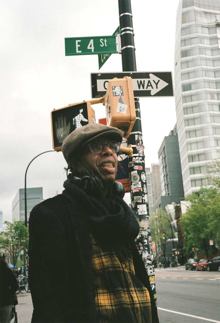 Electric stands on a corner in the East Village, where he has spent years writing, directing, and composing projects at theaters and venues in the neighborhood.