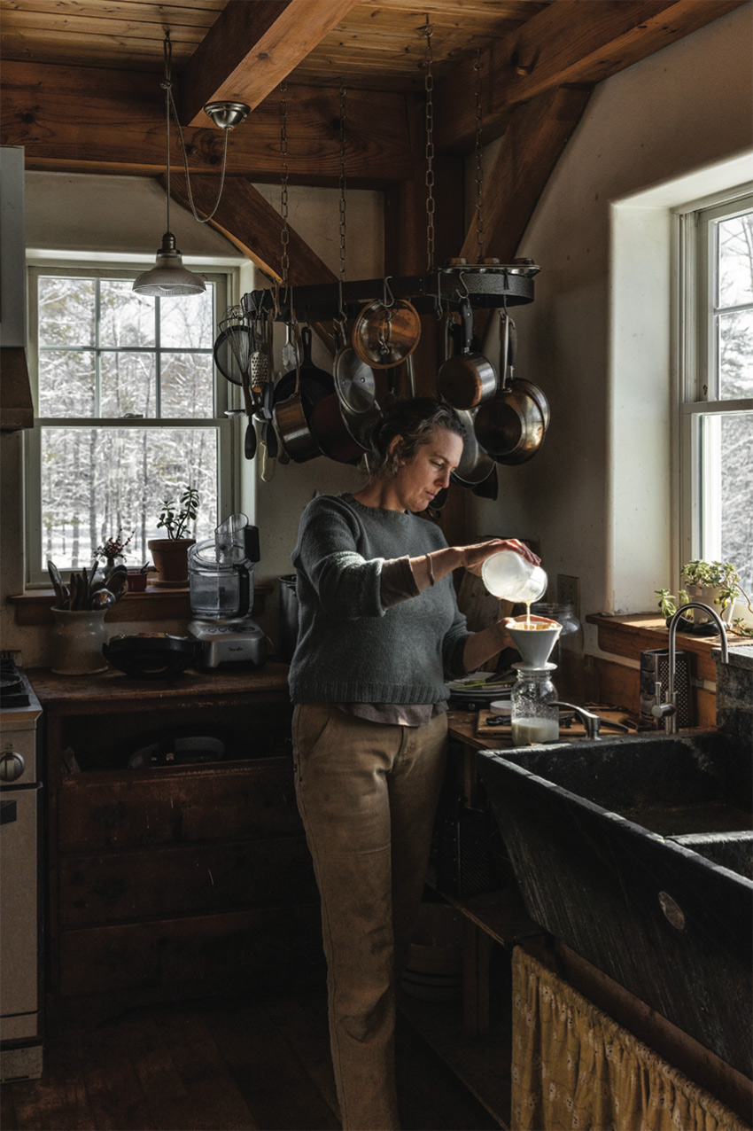 Amy strains goat milk, which they drink and use to make yogurt and cheese, through a coffee filter.