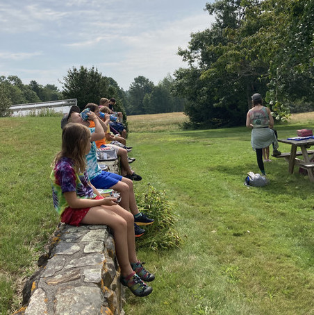 Campers sit on a stone wall