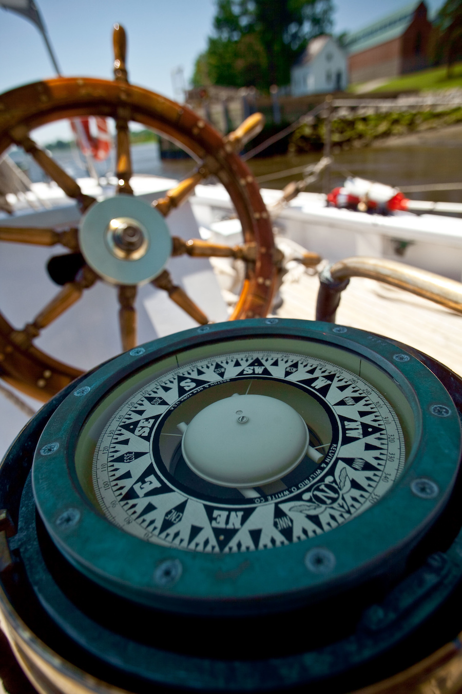 The schooner's beautiful compass, with steering wheel behind