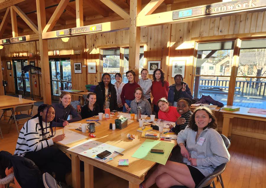 Students on the retreat in the great hall at Camp Wavus.