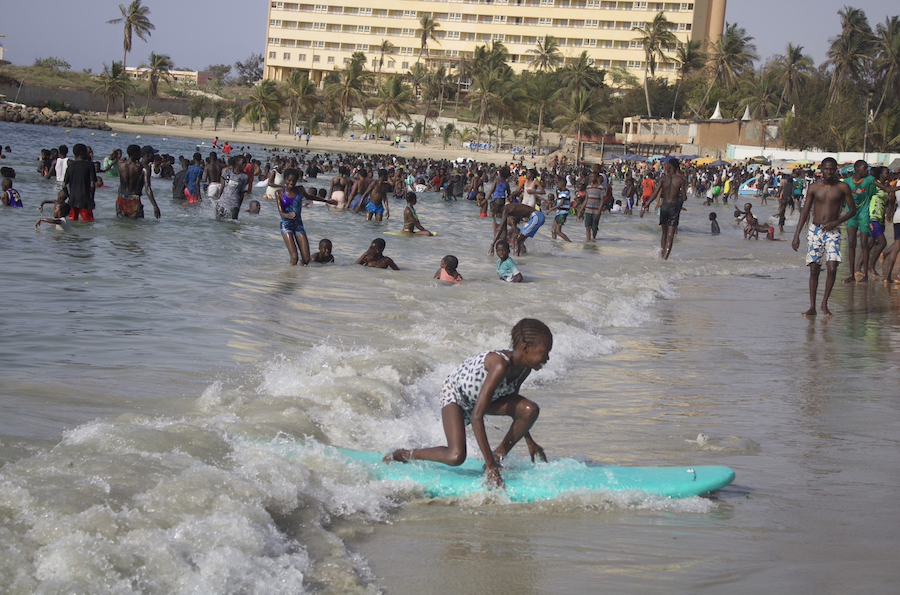 A young girl catches a wave.
