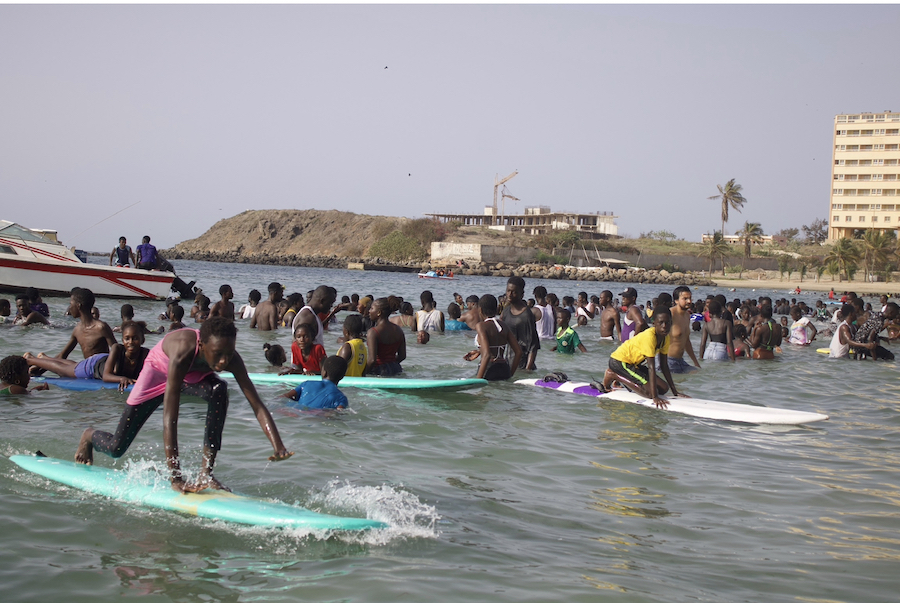 Young people catching waves.