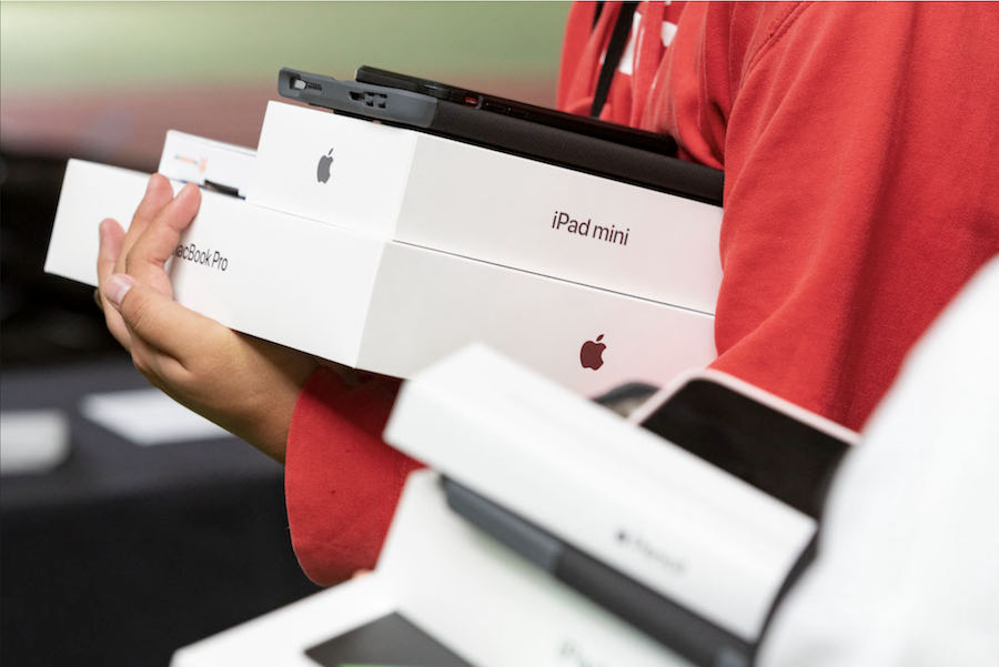 student carries boxes of her new computer equipment