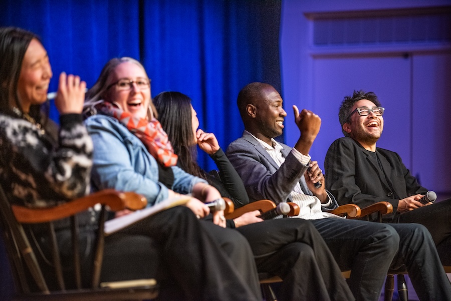 The panel shares a laugh. 