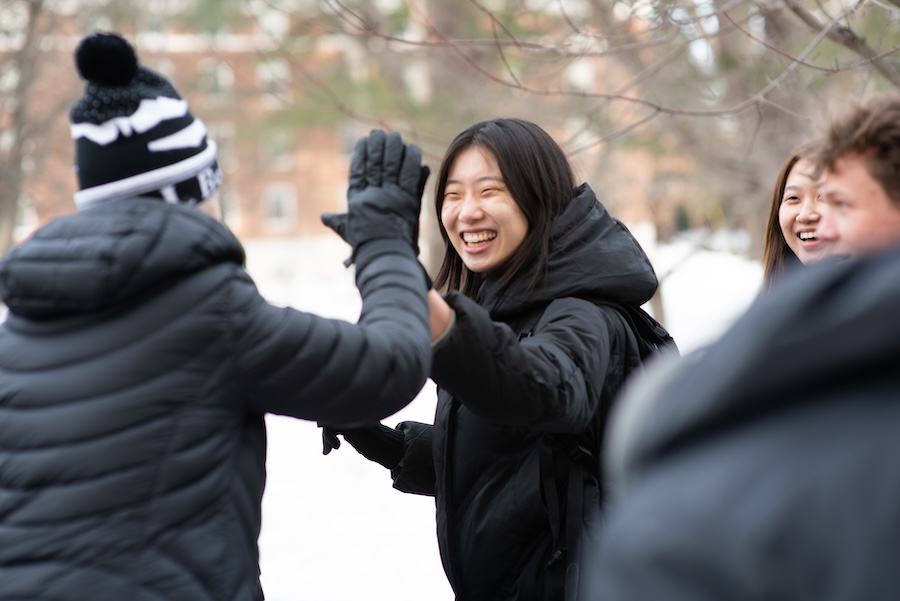 Students greet each other on campus