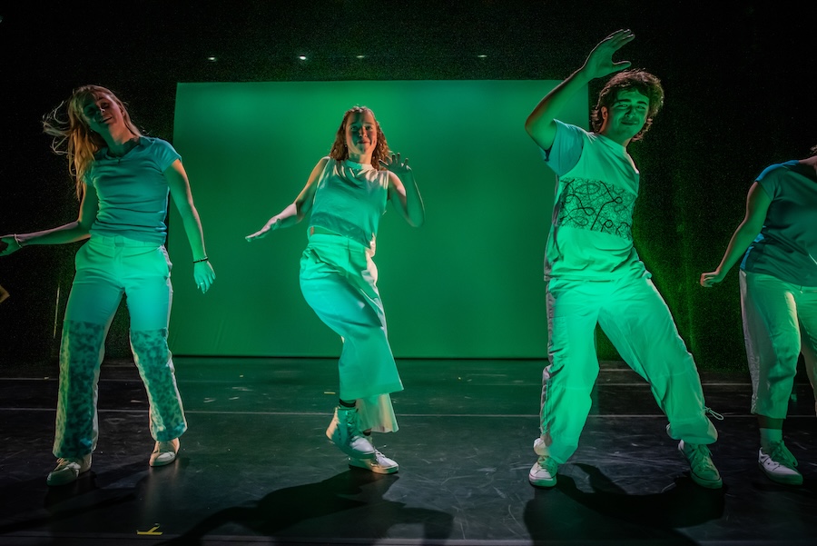 dancers bathed in green light