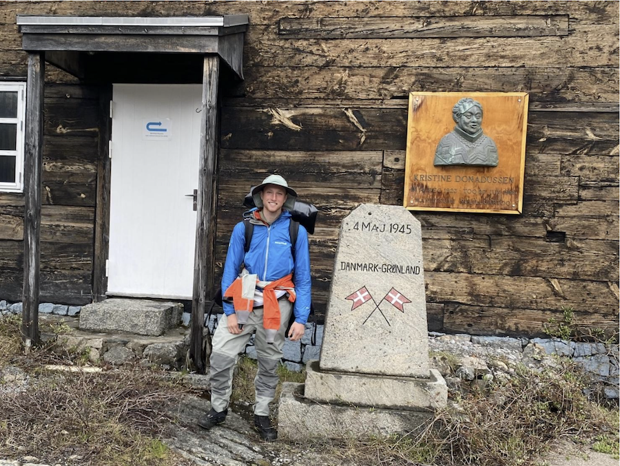 Standing in front of a rustic hut in the Arctic