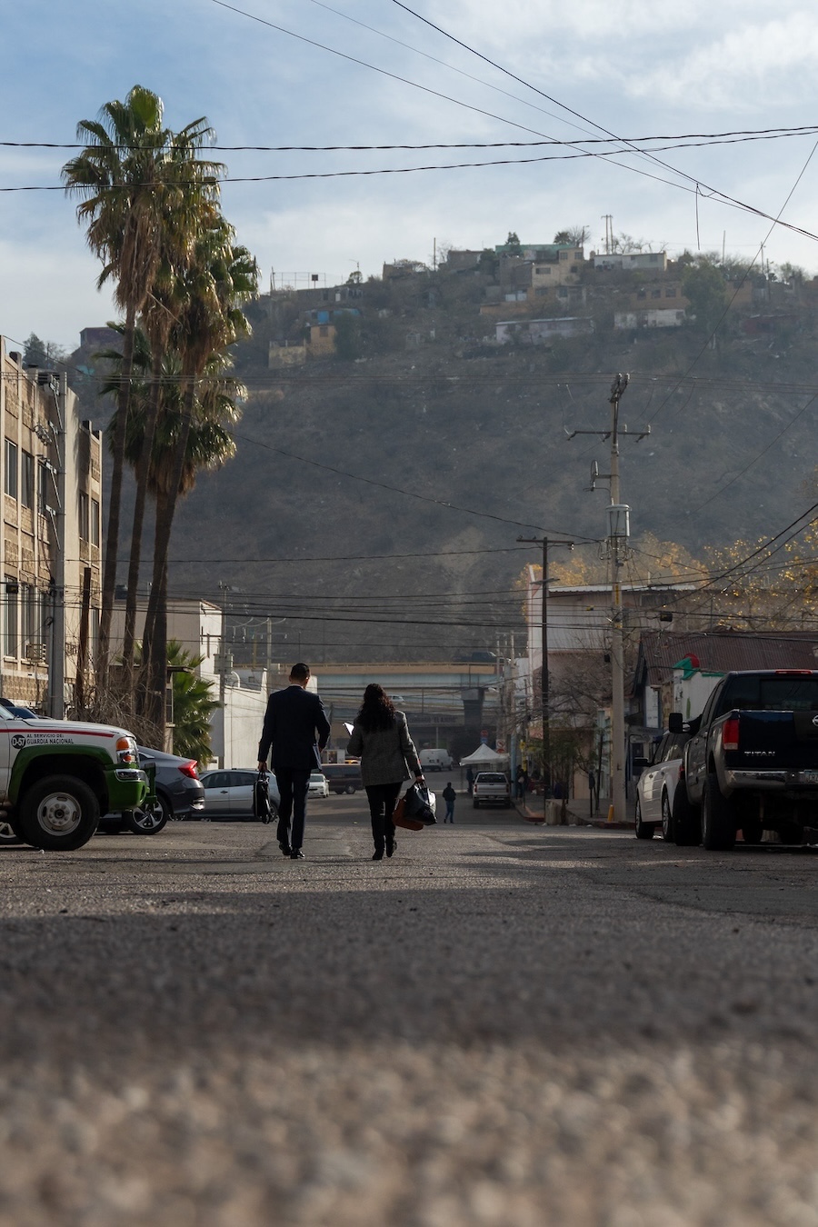 Bill De La Rosa and his mother, Gloria, walk the streets of Nogales as they head to the border