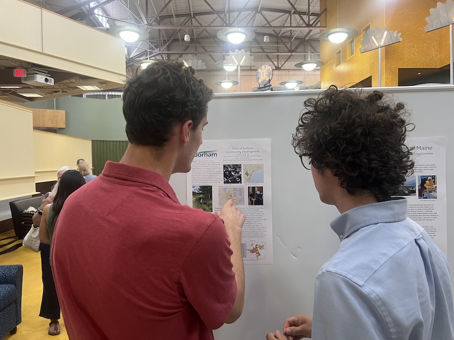 people mingle at the poster event