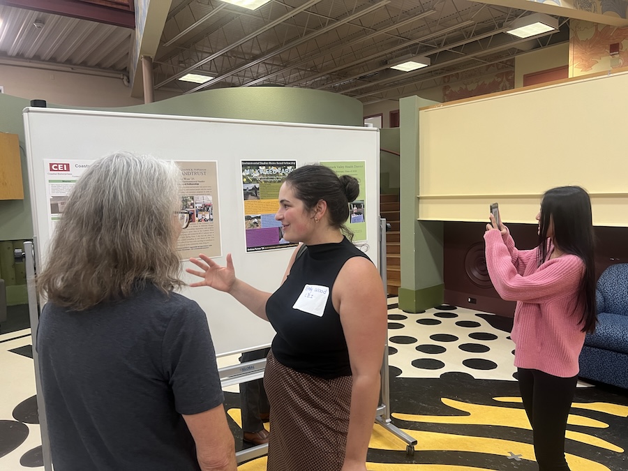 people mingle at the poster event
