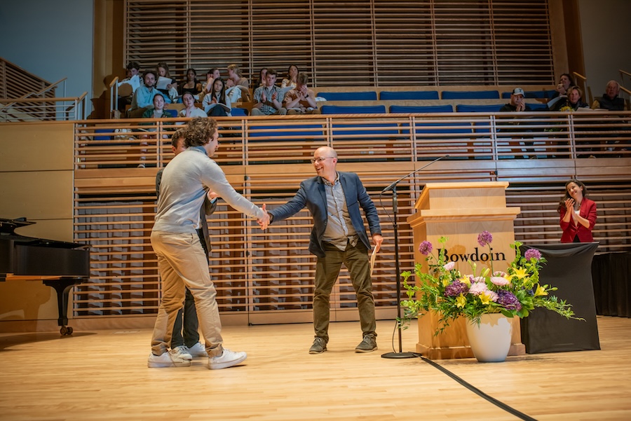 Reed Johnson shakes a student's hand