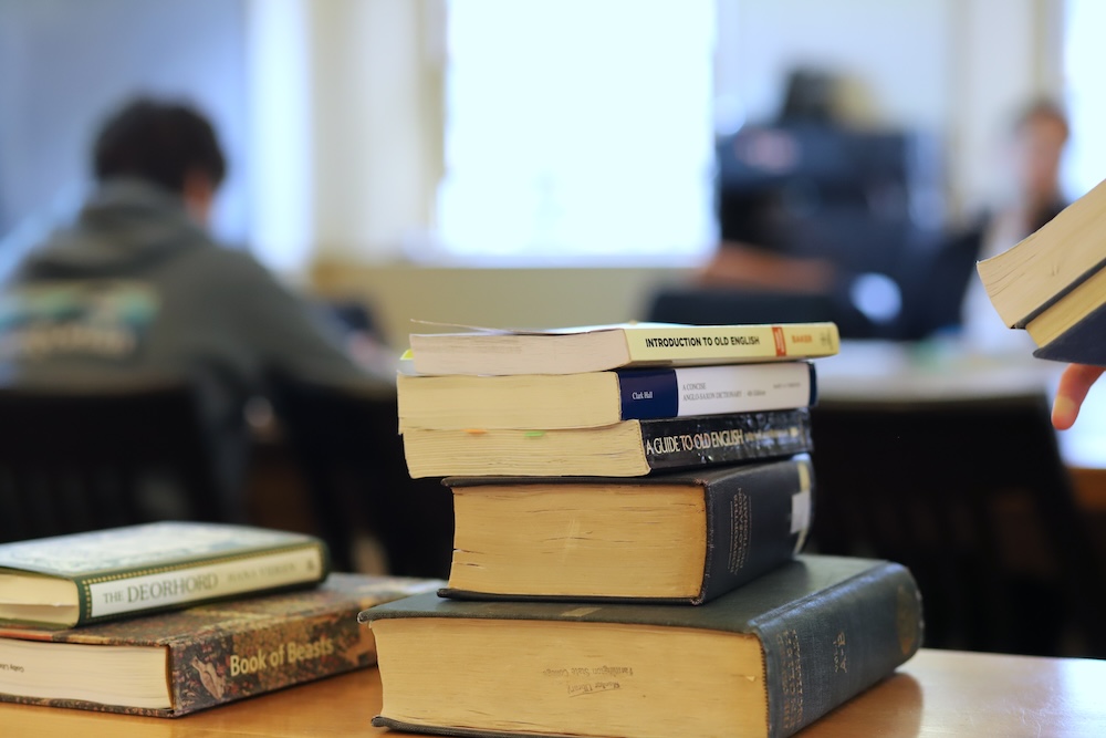 a stack of books in an English classroom
