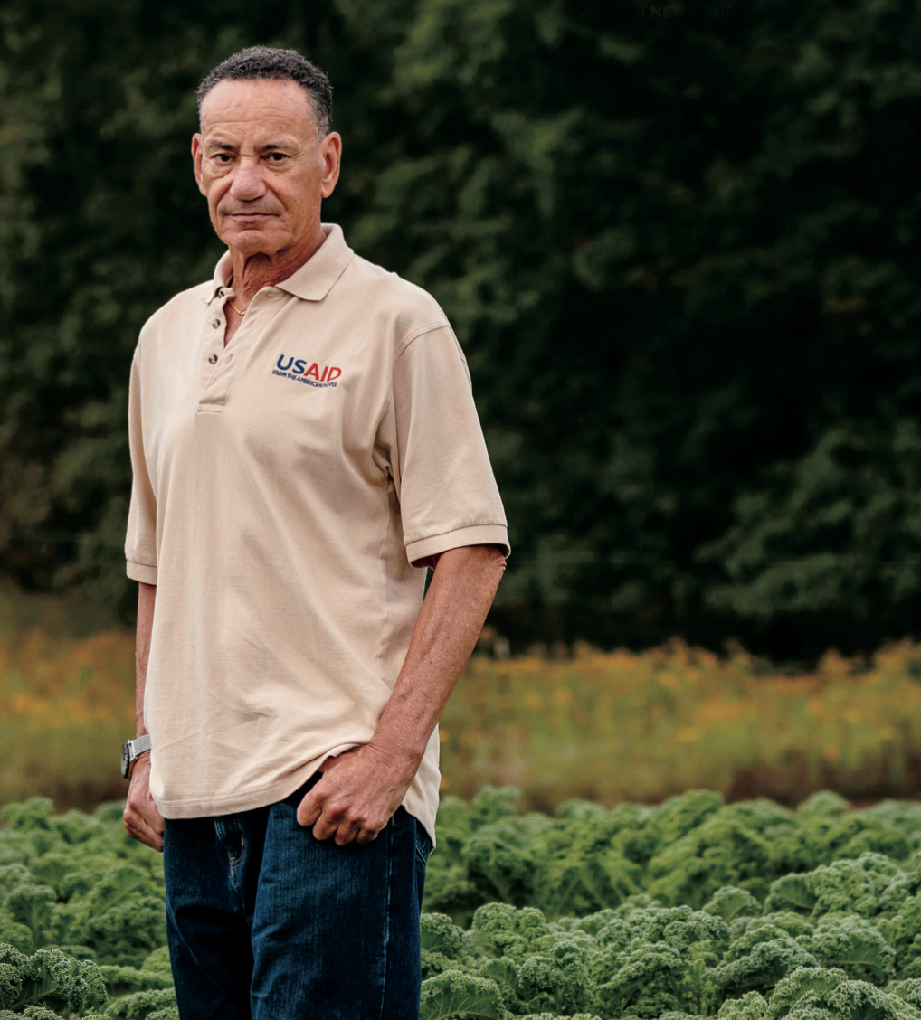 John Bowman '76 in a field of ripe kale. Photo by Nick Hagen.