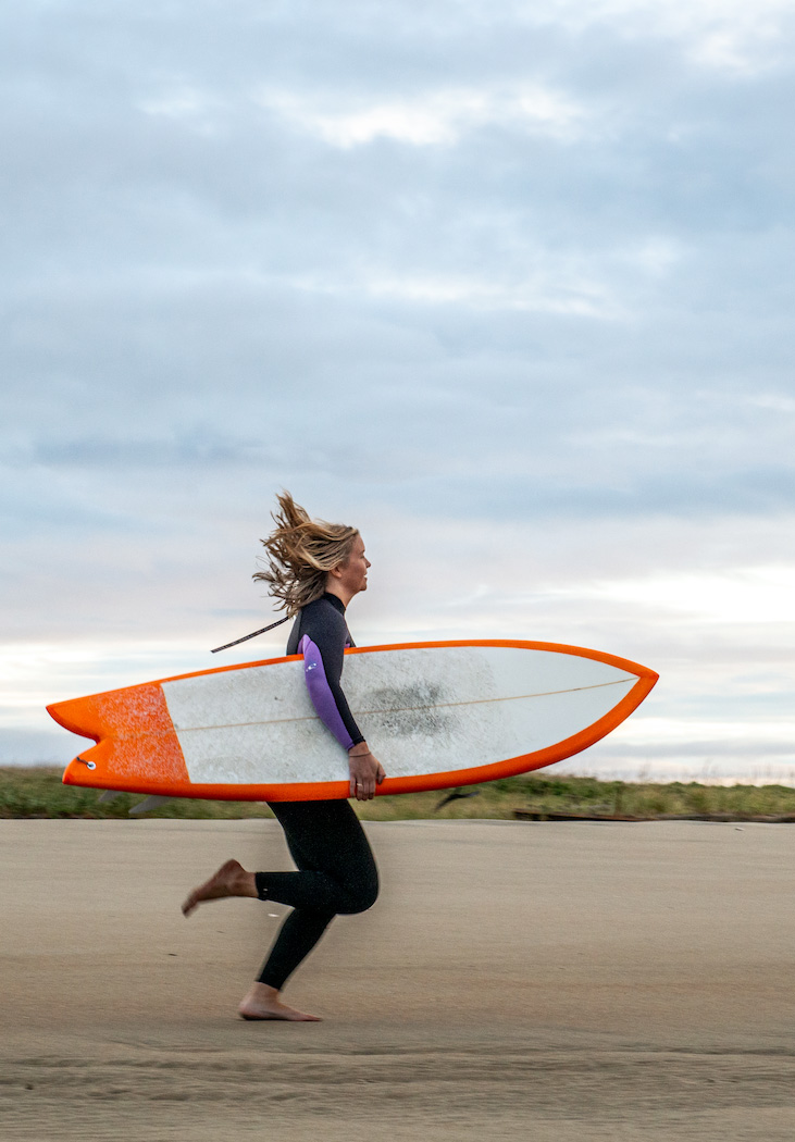 Running toward the waves, in a photo by Heather Perry.