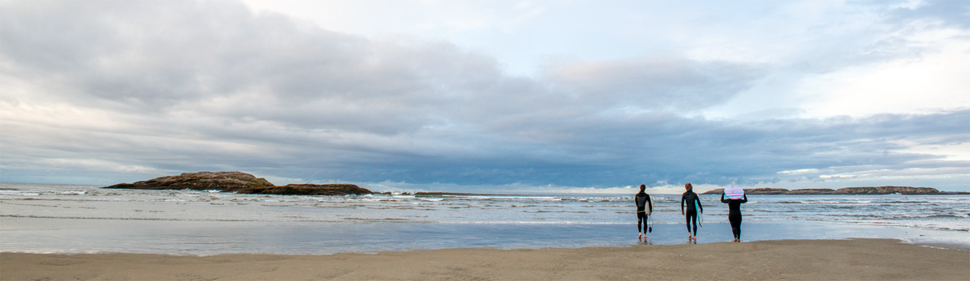 Three Bowdoin surfers head out in the chilly morning. Photograph by Heather Perry.