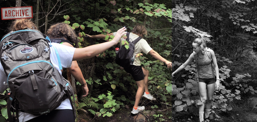 Moments, students hiking over mud