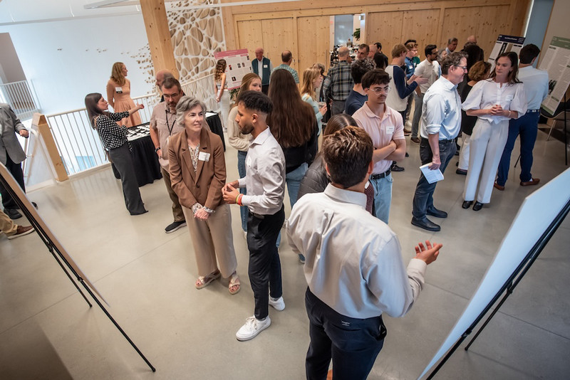 wide shot of Econ200 student poster presentation