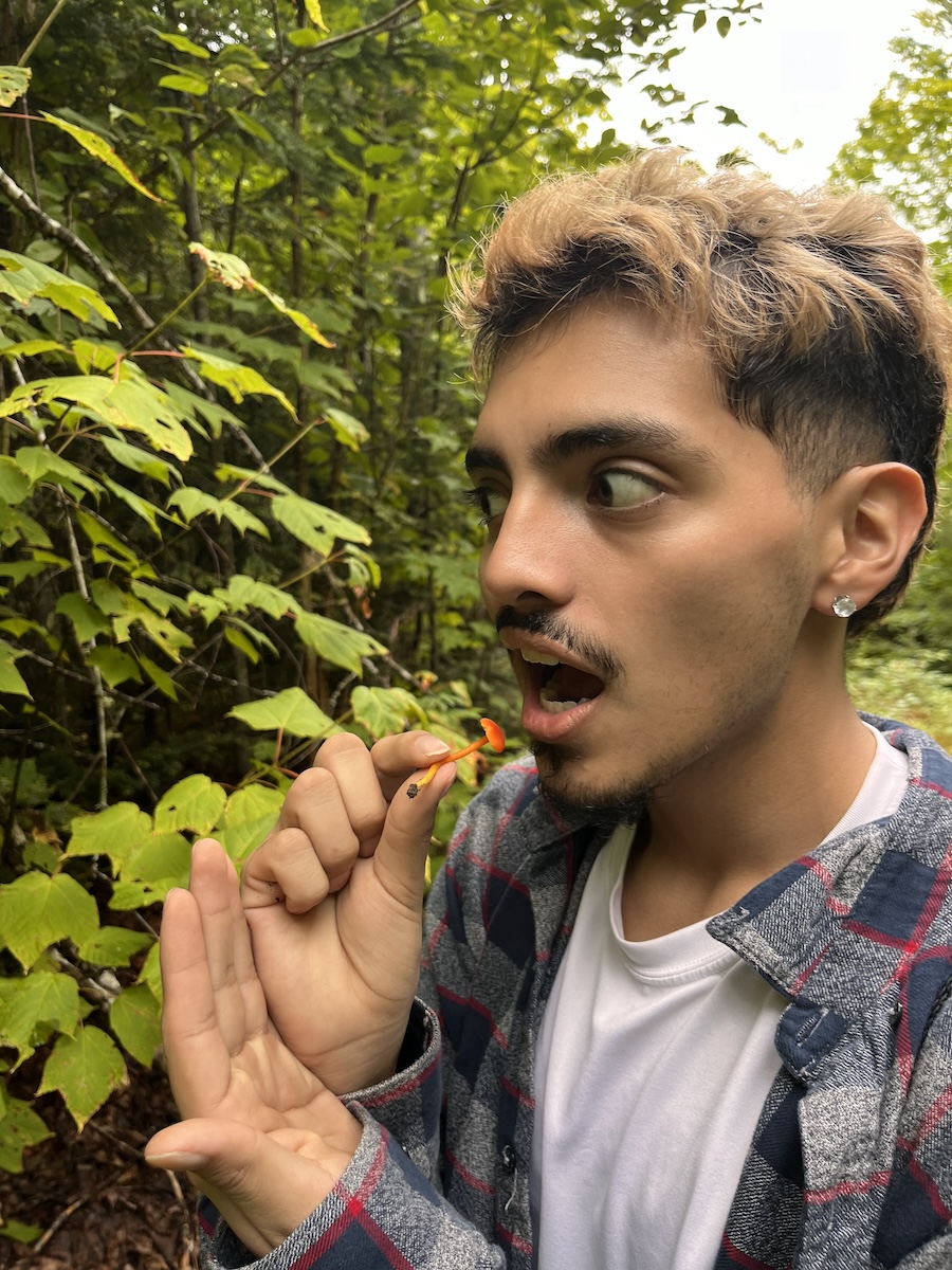 student pretends to eat a mushroom