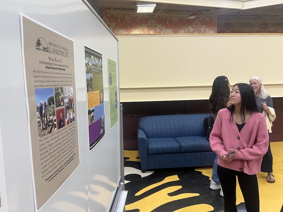 student checks out a poster
