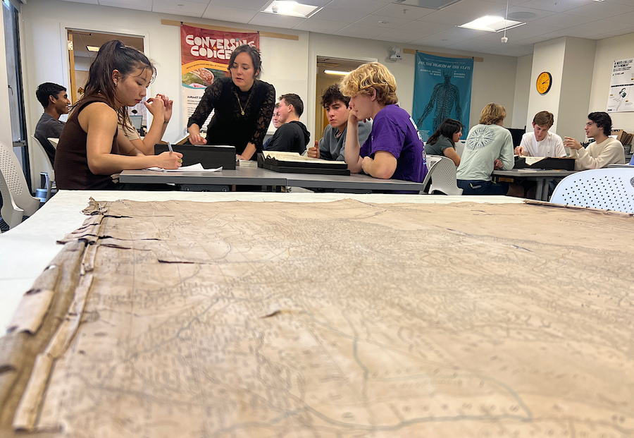 Students and Sakura discuss a map