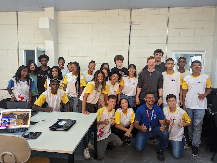 Bowdoin students pose with teenagers in a coding class.