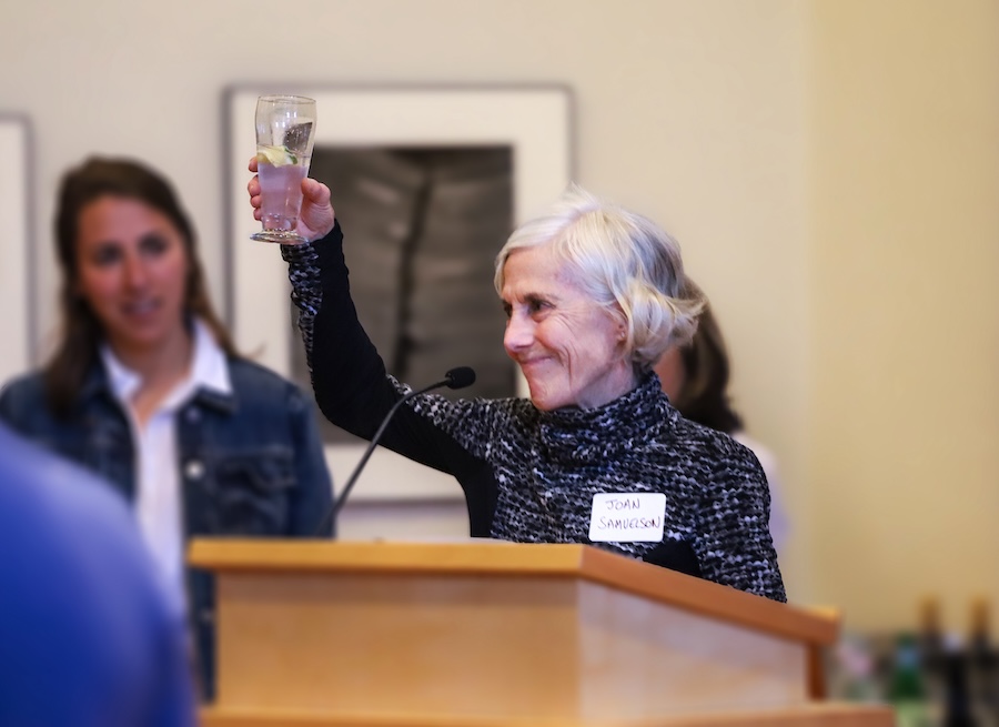 Joan Benoit Samuelson toasts the first woman graduate of Bowdoin