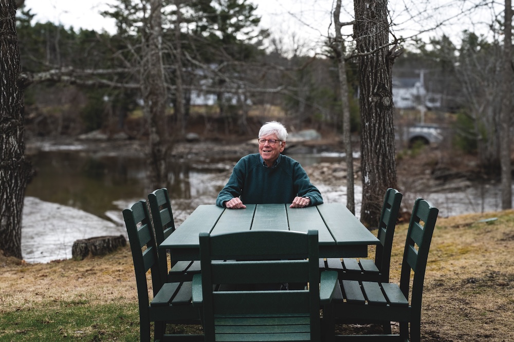 Allen Wells seated at table outdoors