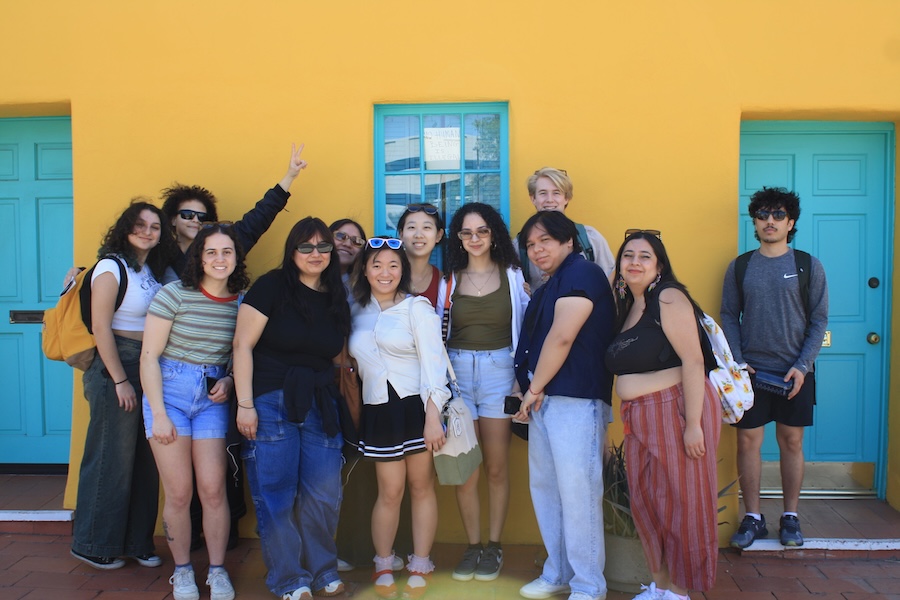 Students on the Belize ASB trip in front of a yellow wall