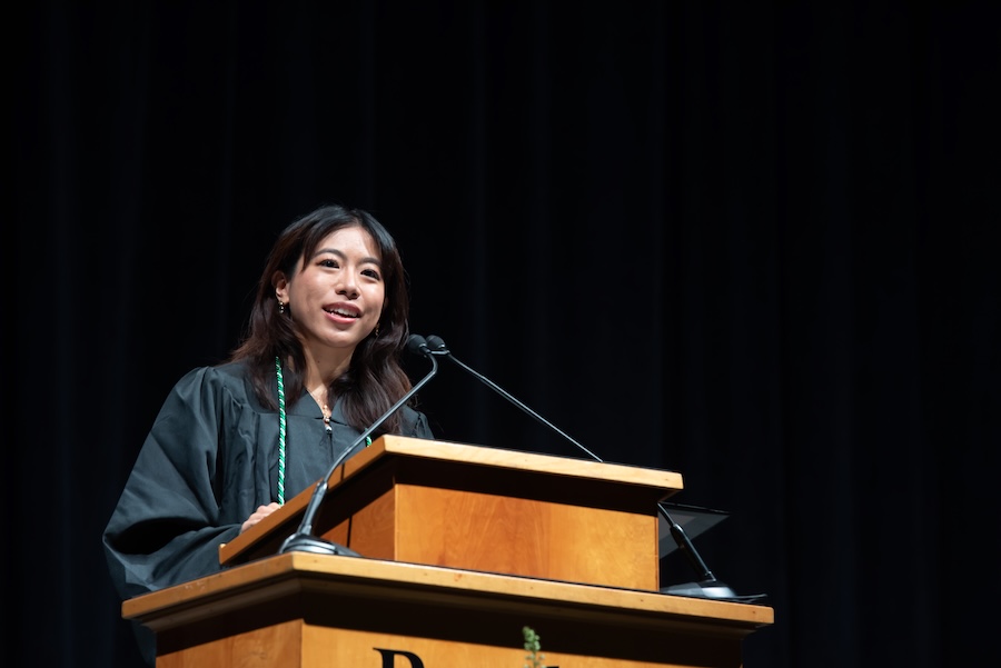 Huang speaking at podium