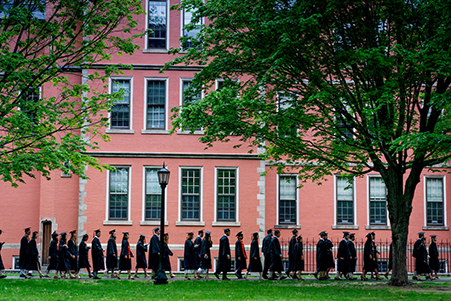 Soon-to-be graduates processing by Searles Hall