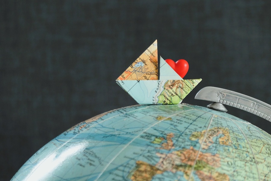 paper ship on the globe