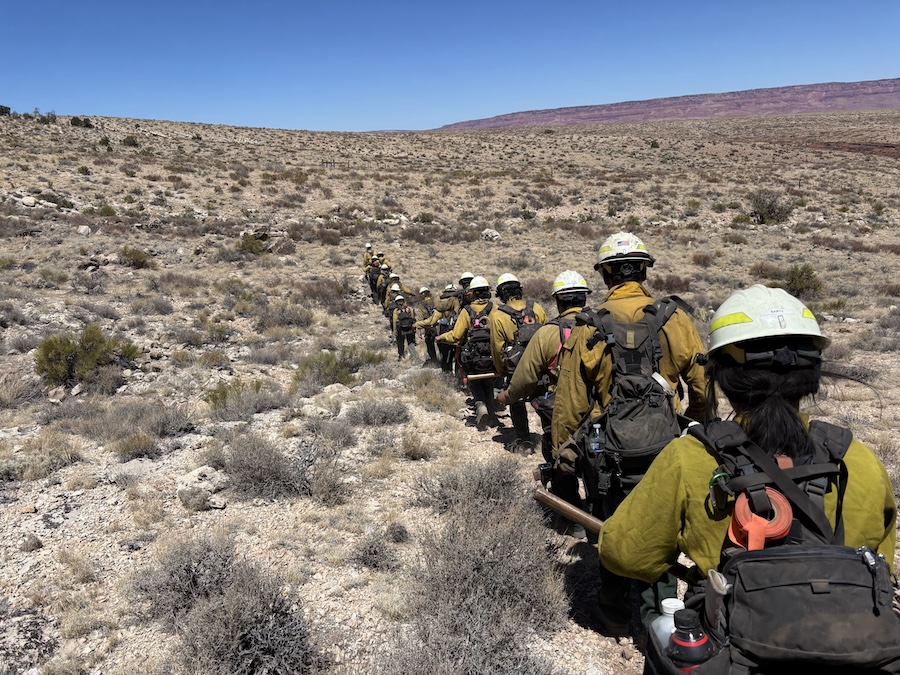 Jade Bartz in Wyoming, hiking a mountain in firefighting gear