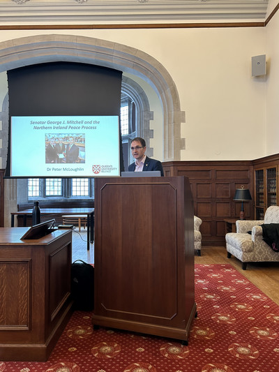queens university's peter mcloughlin at podium in hubbard 