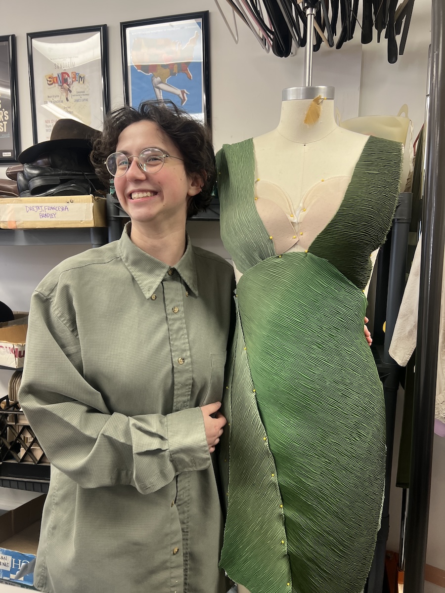 Mira Pickus ’25 with her green dress in the shop.