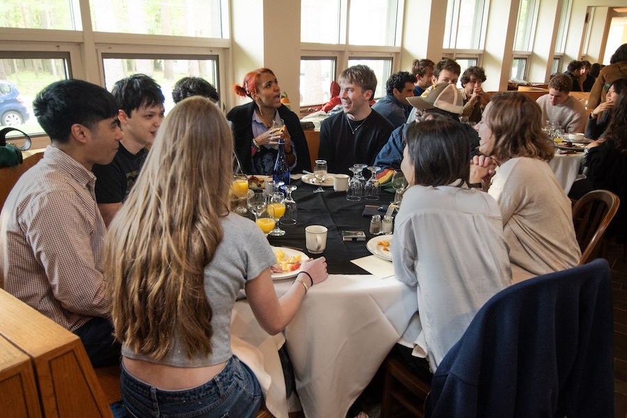 Students talk around a table in Thorne.
