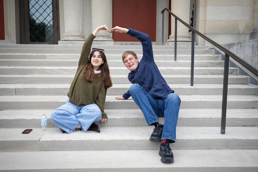Two alumni making a heart