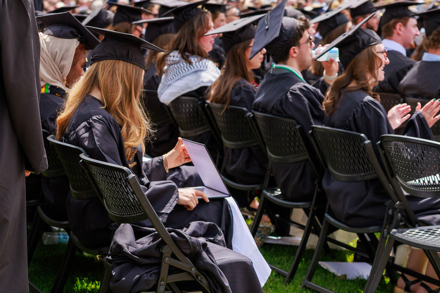 2026 commencement students sitting 